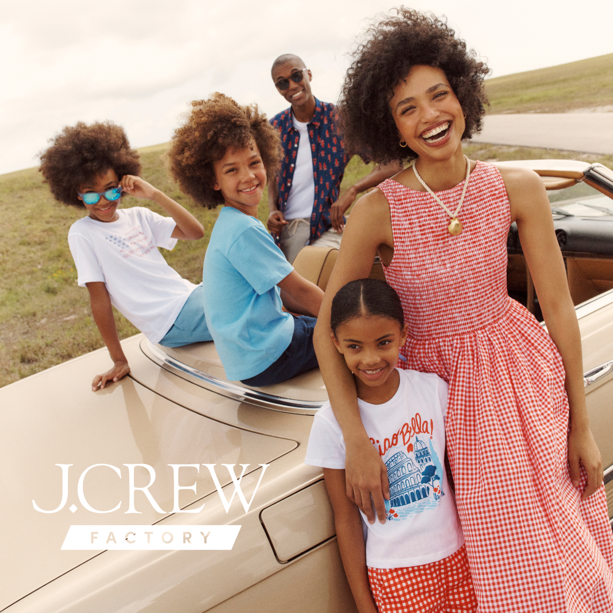 j crew picking a christmas tree loading it on back of pick up truck happy family