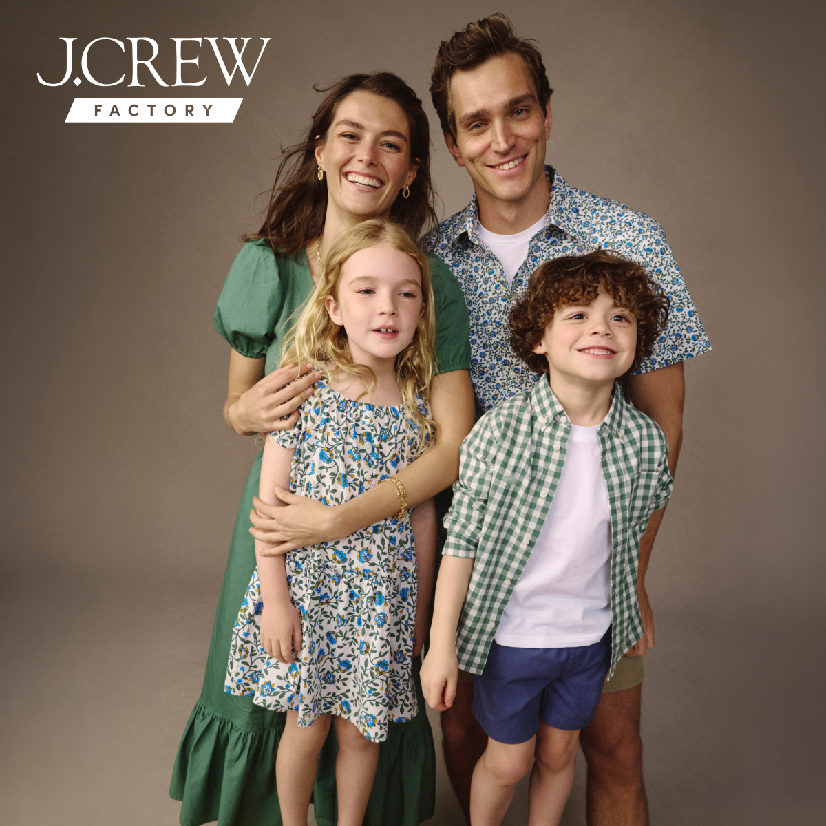 j crew picking a christmas tree loading it on back of pick up truck happy family