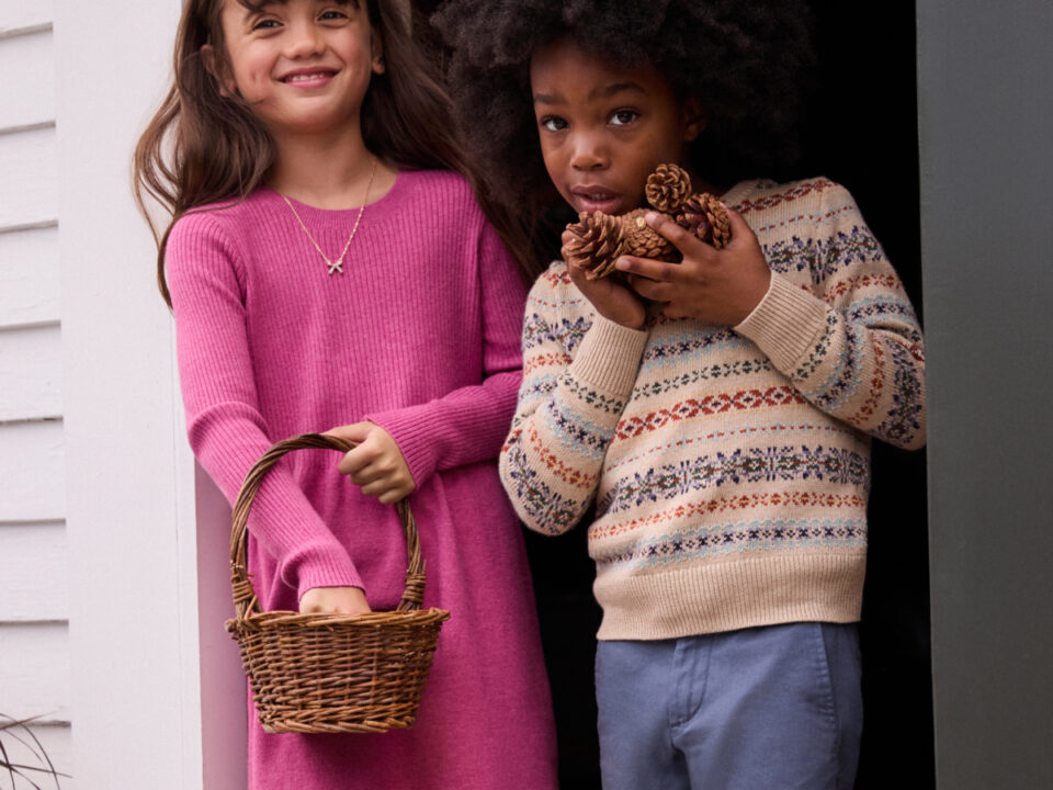 J. Crew kids girl in pink dress and boy wearing sweater and jeans with basket and acorns at doorway shopping deals special offers sunset valley austin tx